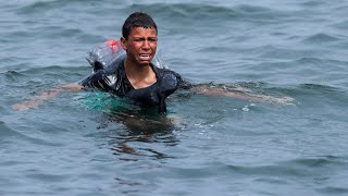 Ceuta Migrant boy swims to shore with plastic bottles tied to himself [upl. by Eluj612]